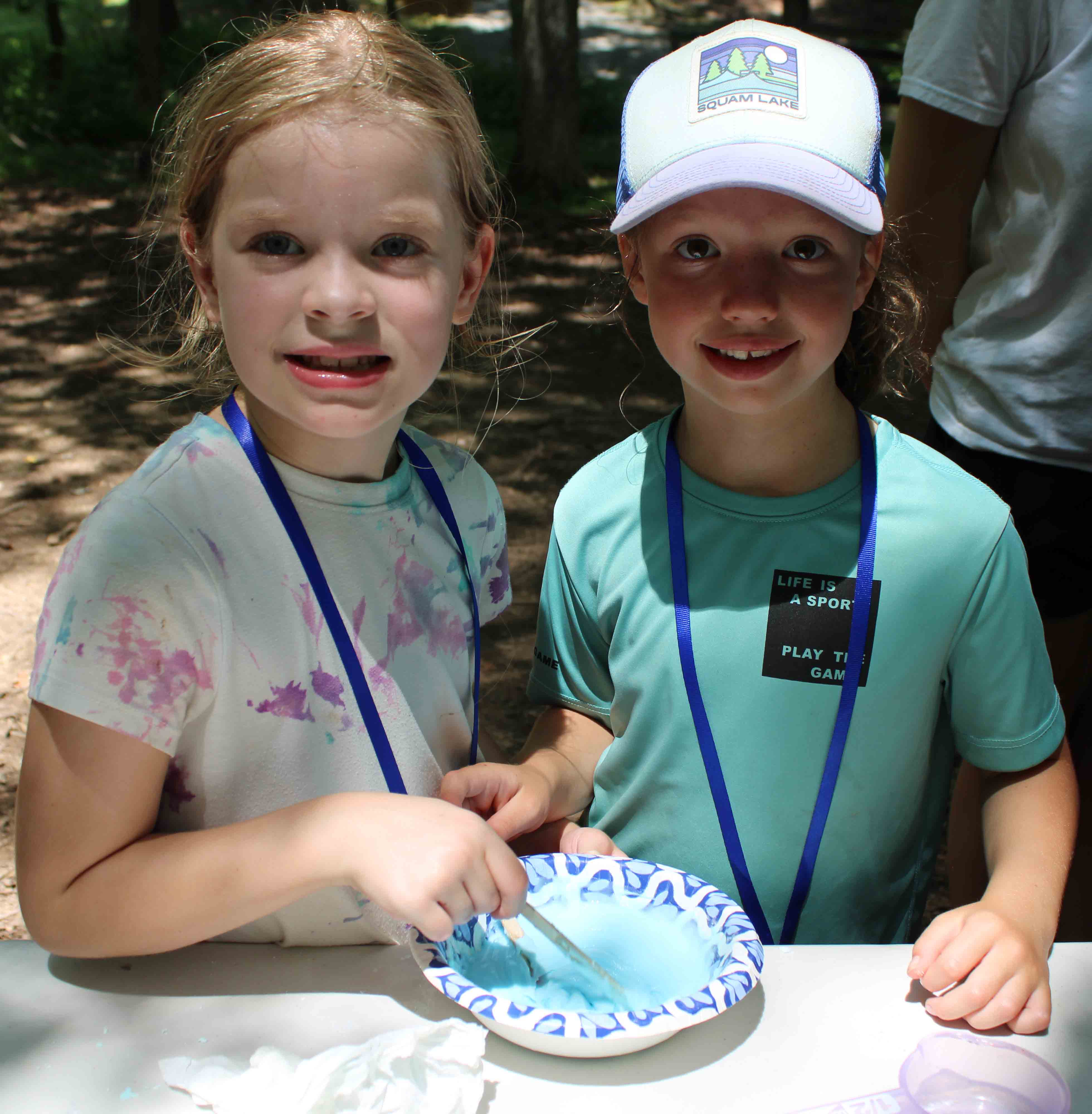 Three Catapults unit campers standing side-by-side outdoors under the trees.