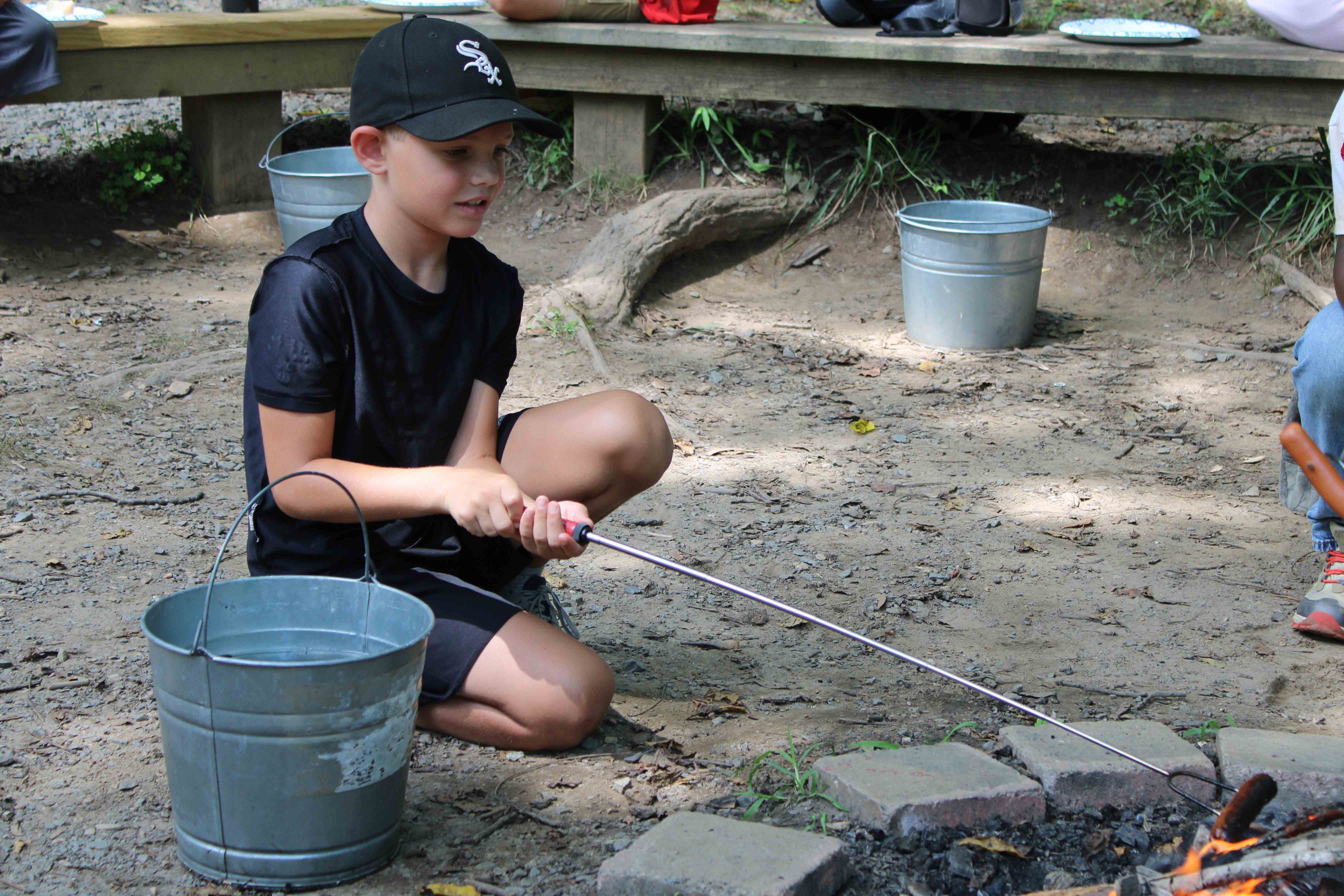 A camper working with colorful pipe cleaners to craft custom bubble wands.